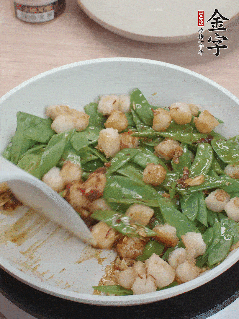 下甜豆莢、鮮貝輕輕翻炒均勻。
